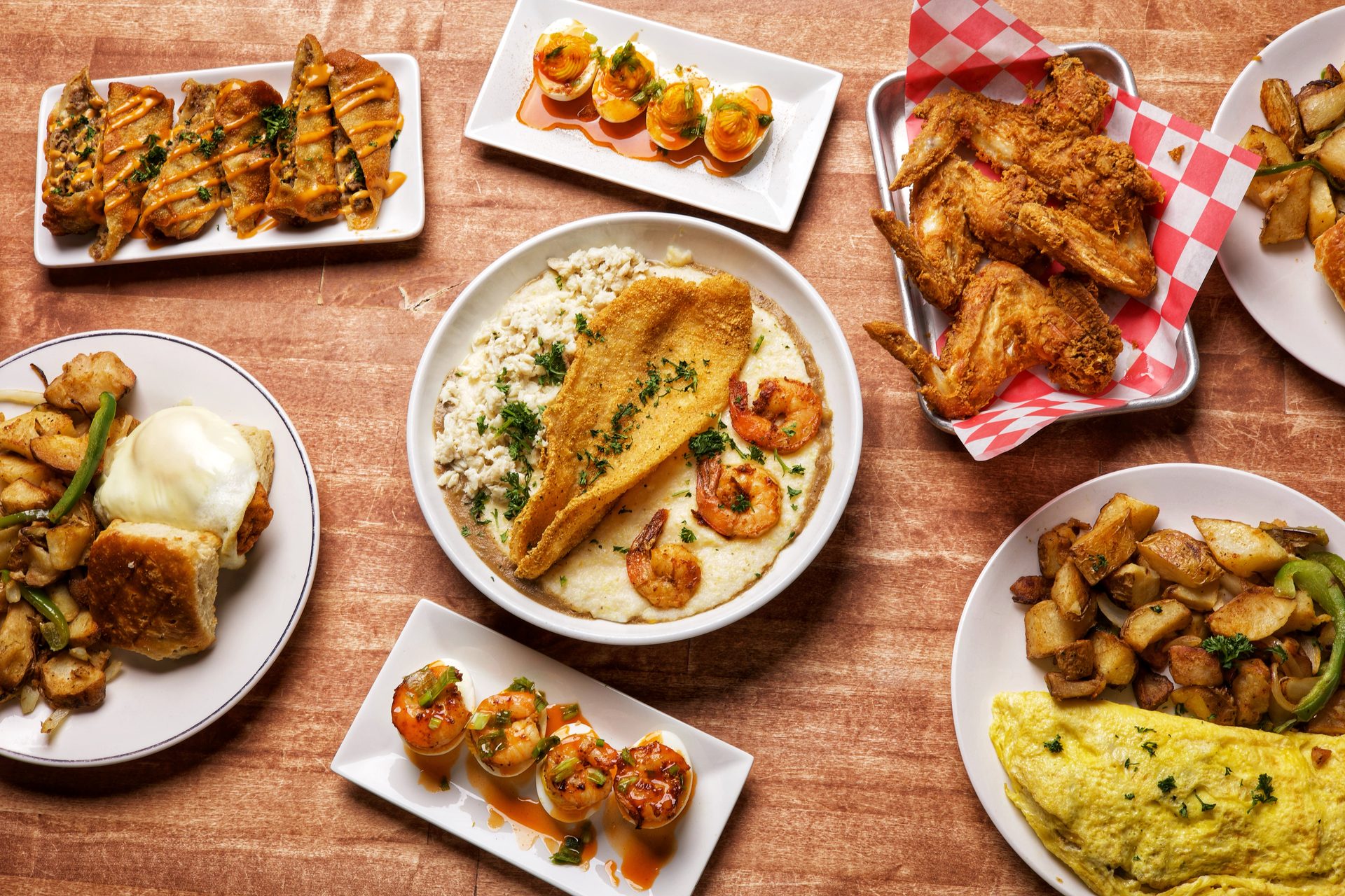 The S.G.G. — Sunrise Social's signature fried catfish, shrimp, and crab over gumbo grits